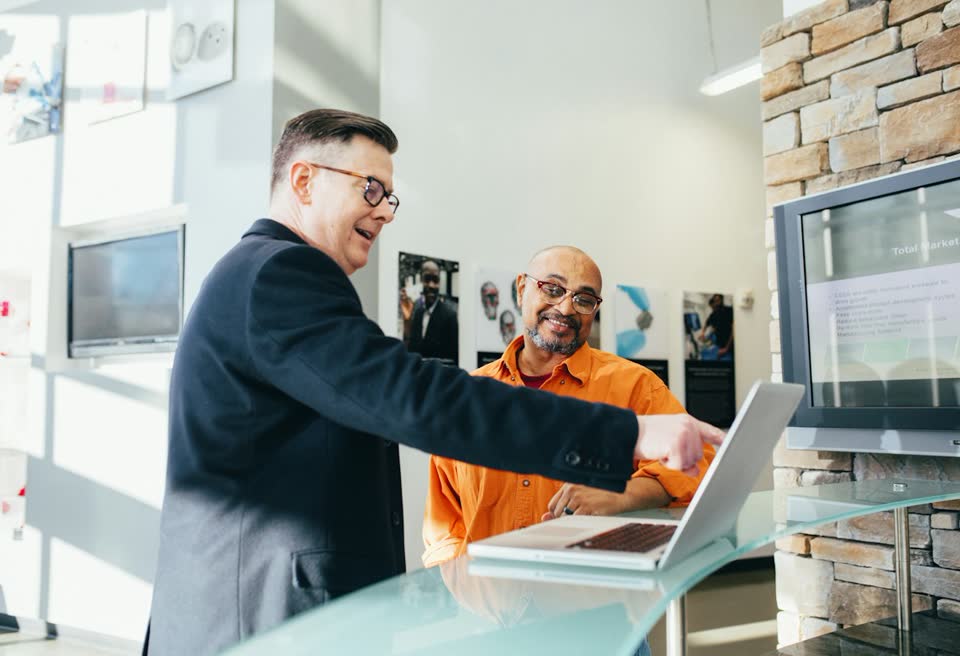 Two colleagues shaking hands in an office