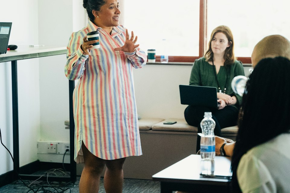A colleague leading a training session in a bright room