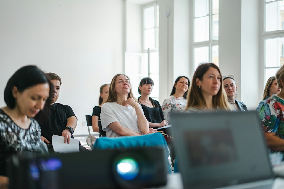 Colleagues attending a workshop in a sunlit room