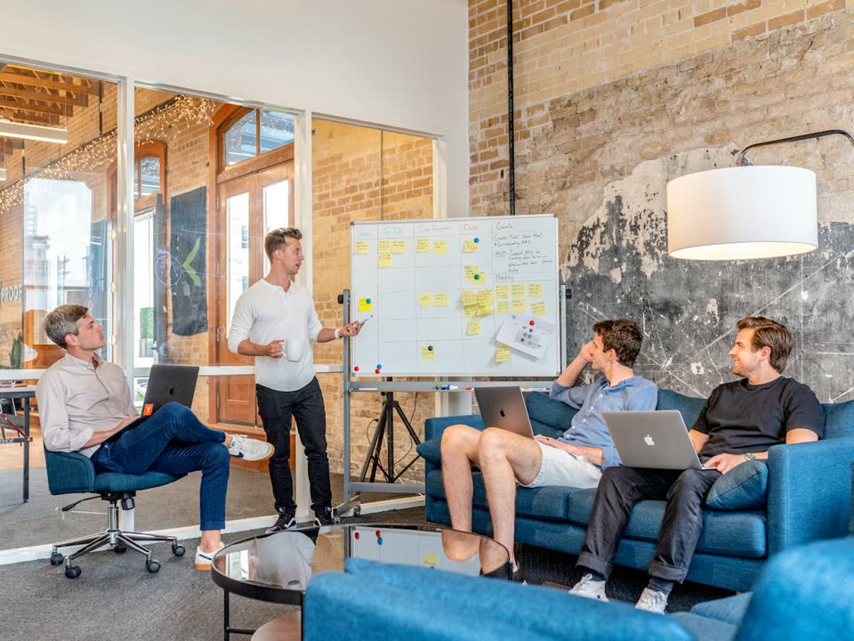 A team in a workshop around a whiteboard