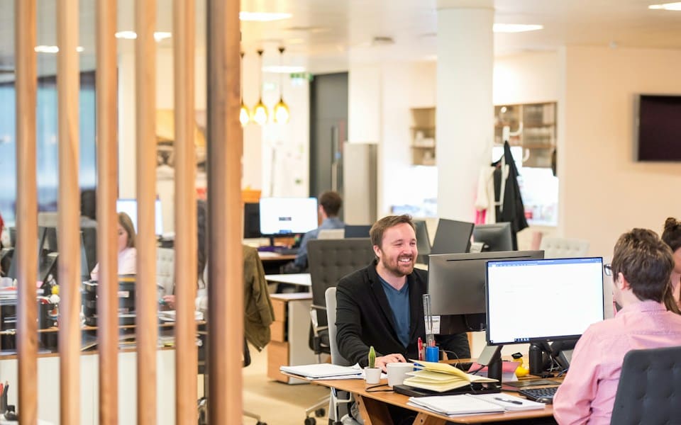 Colleagues at their desks in an open-plan office